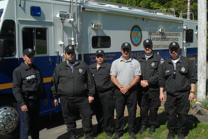 Police officers standing together talking.