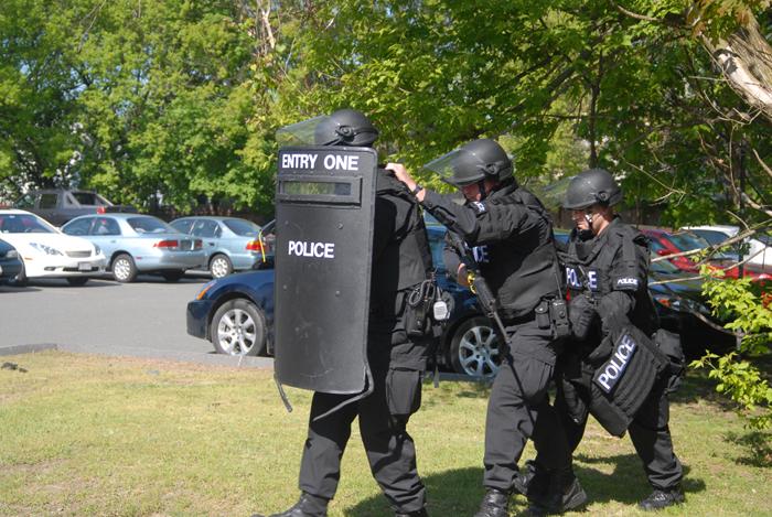 A team of police officers in riot gear.