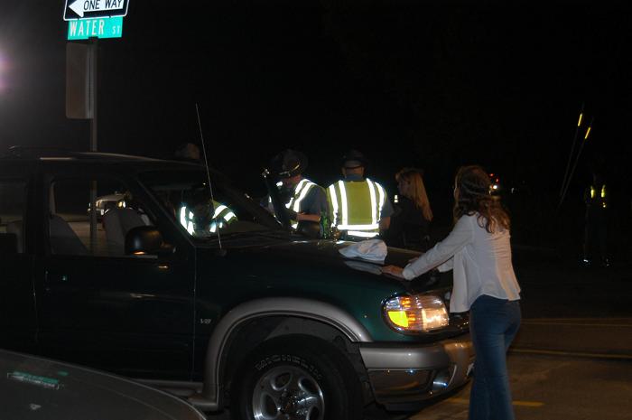 Police looking through a woman's car.